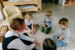 a teacher and 4 children learning