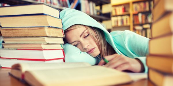 teen sleeping in library
