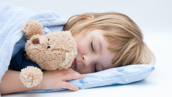 little girl sleeping and hugging her teddy bar