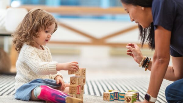 Little girl with prosthetic leg at occupational therapy appointment