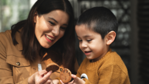 Girl with Autism Eating Cookies with Her Mother