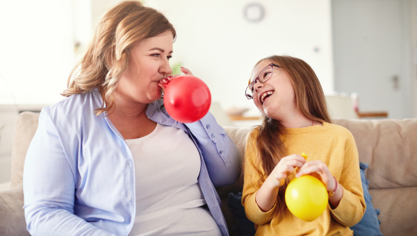 Mother and Daughter Blowing Up Balloons