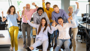 A group of excited professionals in an office