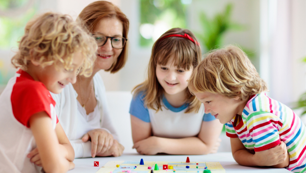 Family playing board game. Kids play.