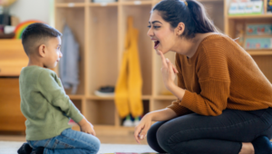 Speech therapist teaching a toddler how to speak