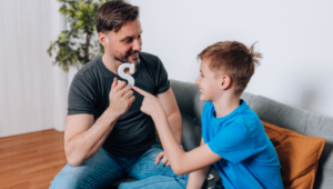 father and son practicing speech therapy with the letter S