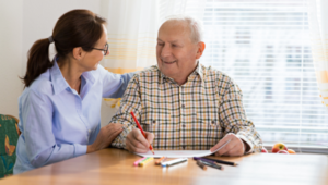 Home caregiver and senior adult man