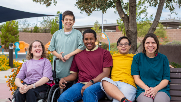 A group of disabled teenagers smiling for the camera